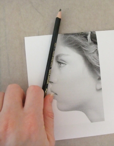Have you ever seen artists when drawing a still life or model lifting their pencil up, squinting at it, and then laying it against their paper? They are using their pencil as a guide to gauge the correct angle, and we can do that with a photo reference as well.  Lay your pencil against the angle of the forehead to gauge the angle start, and then move the pencil over to your paper and create that same angle.